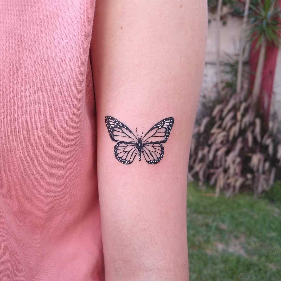 female butterfly tattoo on forearm