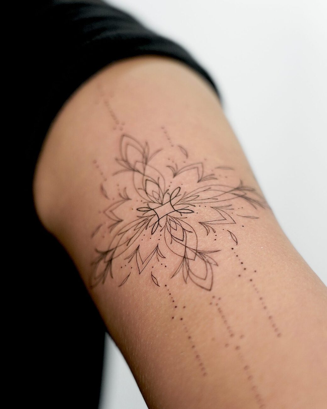 delicate feminine tattoo on forearm