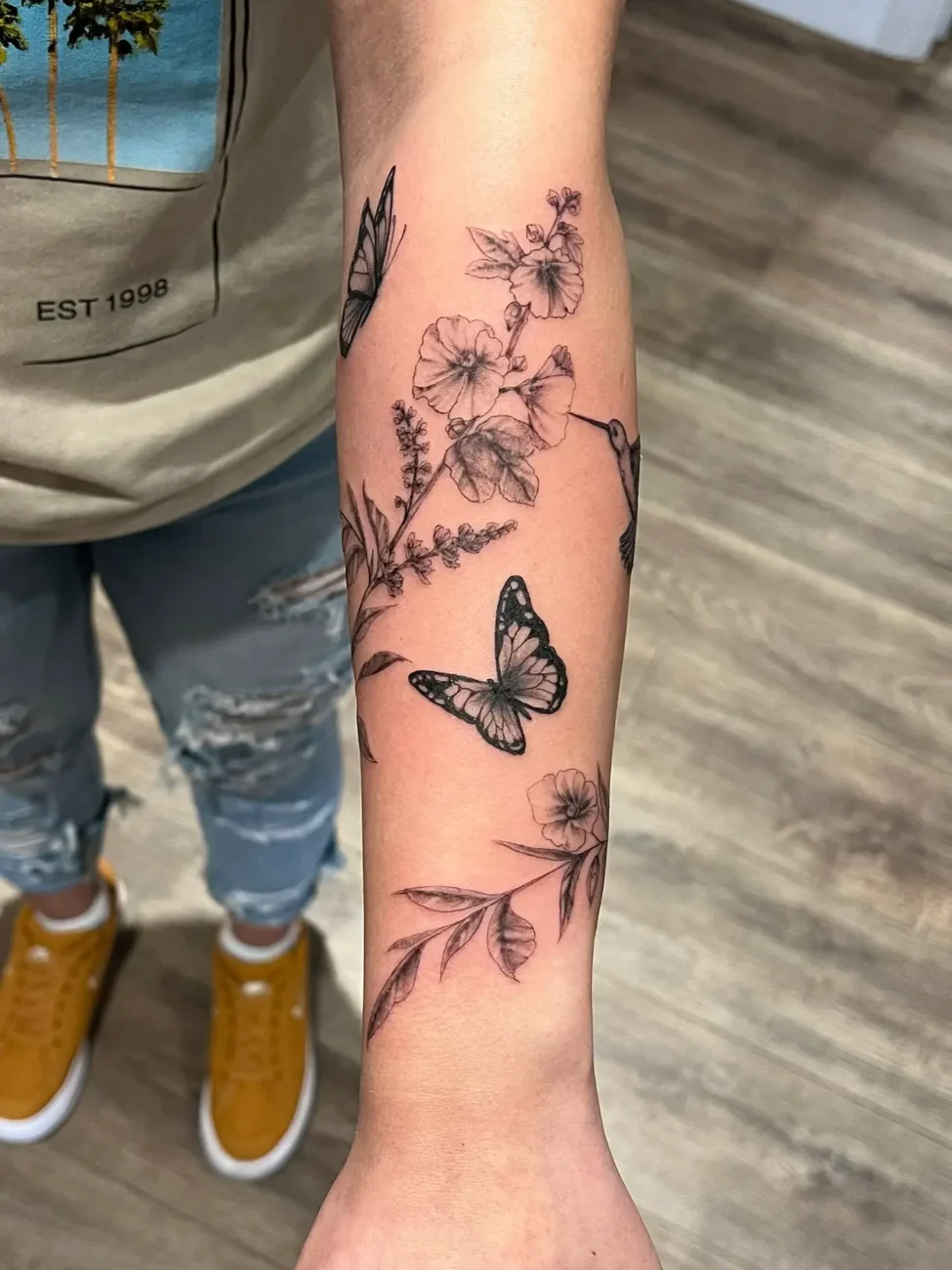 female butterfly tattoo on forearm