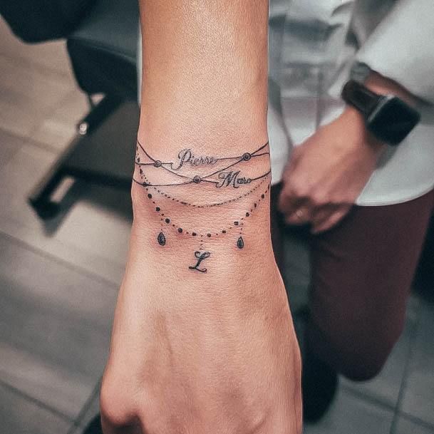 female bracelet tattoo