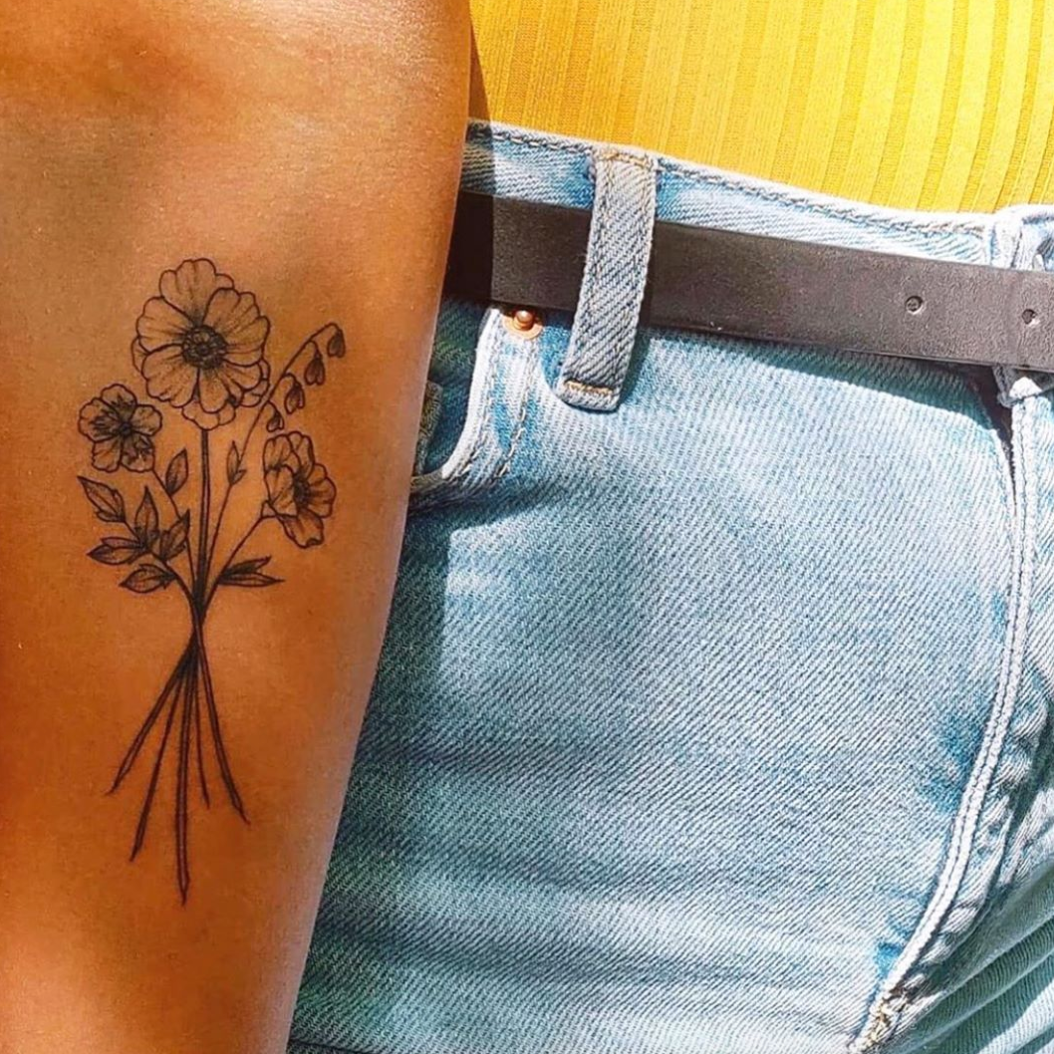 female tattoo on forearm flowers