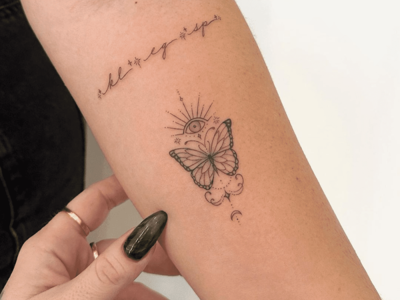 female butterfly tattoo on forearm